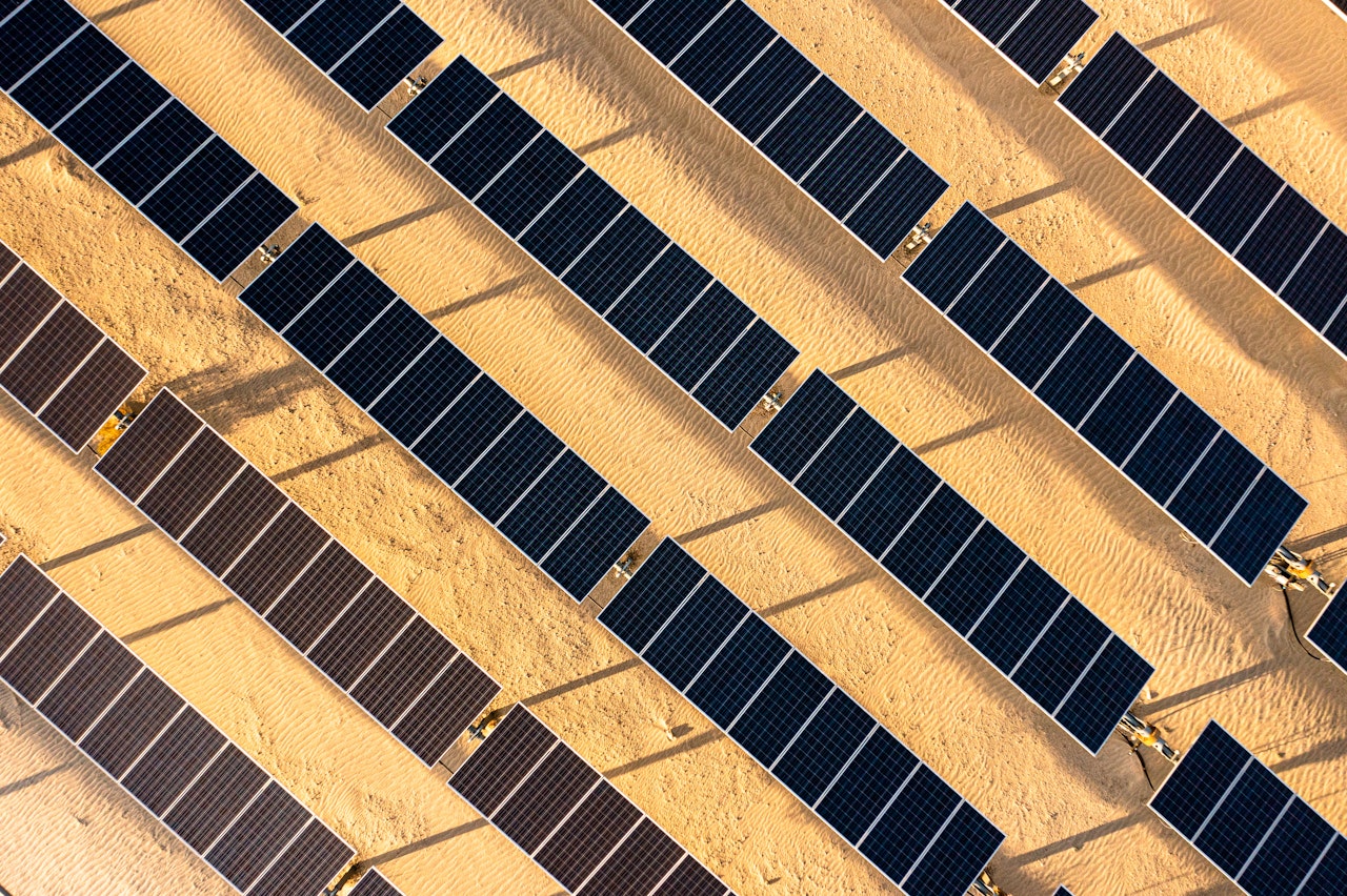 Photo depicts aerial Sunrise View over Solar Panels in Palm Springs California