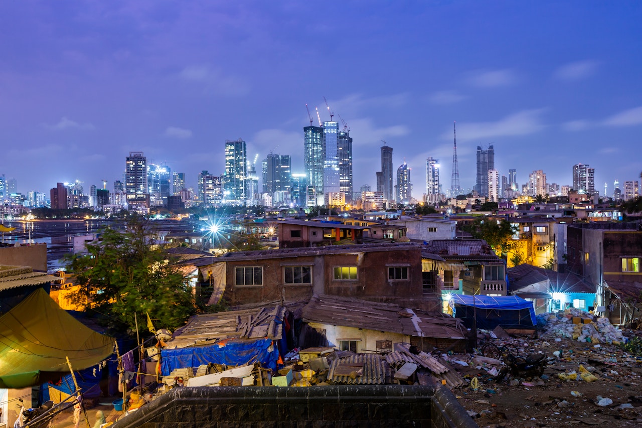 Photo depicts Night skyline of Mumbai photographed from Worli fort with the village in the foreground. Encroachment and development in the same frame.
